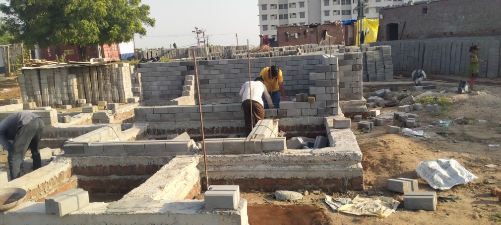 First interlocking brick course above plinth